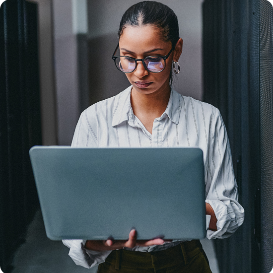 A woman looking at an open laptop